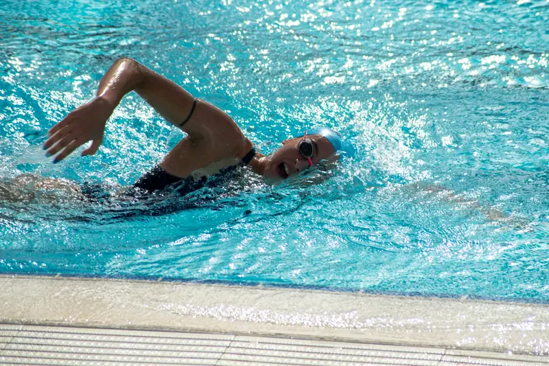 A swimmer turning their head to the side to breathe during front crawl